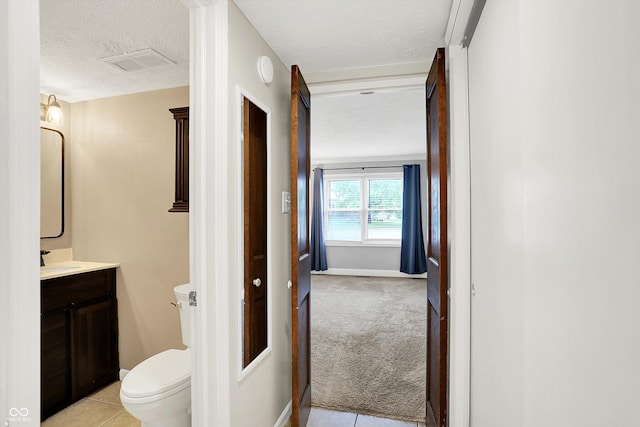 7430 Railway Ct, Indianapolis, IN 46256 - bathroom with toilet, vanity, a textured ceiling, tile patterned floors, and baseboards