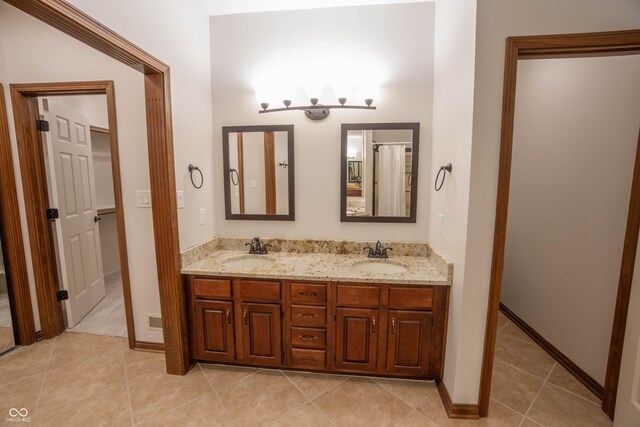 1188 Old Eagle Way, Greenwood, IN 46143 - full bathroom with double vanity, tile patterned flooring, and baseboards