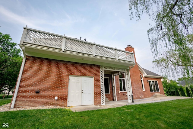 1188 Old Eagle Way, Greenwood, IN 46143 - back of property featuring brick siding, a balcony, a chimney, a lawn, and entry steps