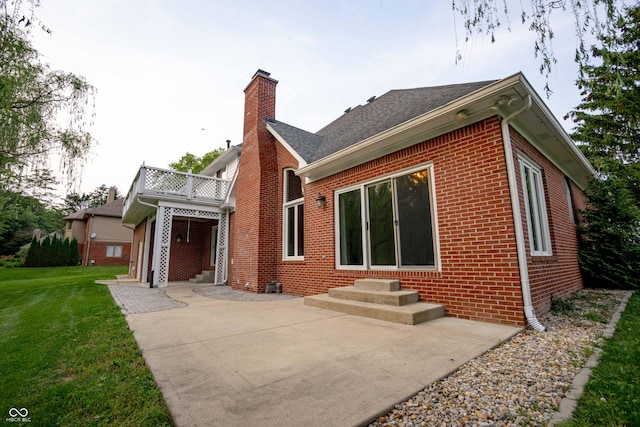 1188 Old Eagle Way, Greenwood, IN 46143 - rear view of house featuring brick siding, a chimney, a lawn, a patio, and entry steps