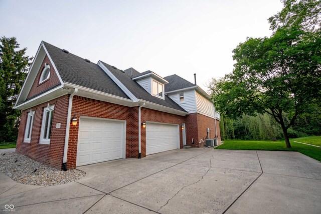 1188 Old Eagle Way, Greenwood, IN 46143 - view of side of property featuring brick siding, concrete driveway, roof with shingles, an attached garage, and a lawn