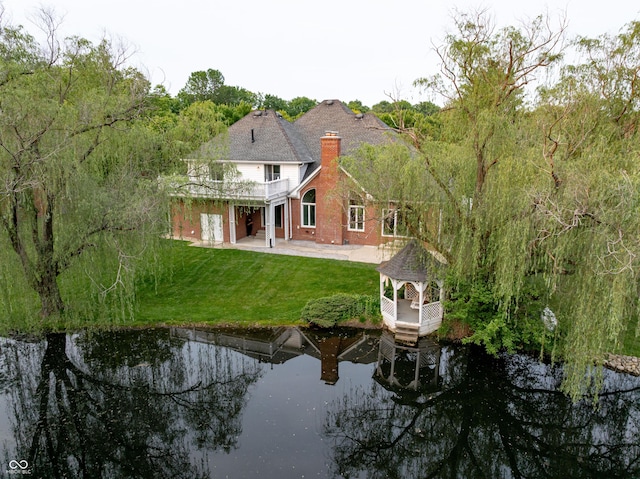 1188 Old Eagle Way, Greenwood, IN 46143 - rear view of house with a patio, a chimney, a yard, a water view, and brick siding