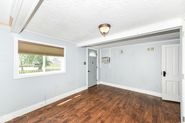 402 E 4th St, Sheridan, IN 46069 - spare room featuring a textured ceiling, dark wood finished floors, baseboards, ornamental molding, and an AC wall unit
