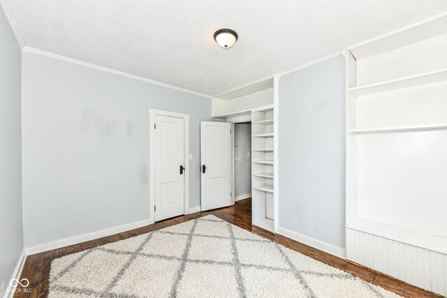 402 E 4th St, Sheridan, IN 46069 - unfurnished bedroom featuring wood finished floors, crown molding, and baseboards