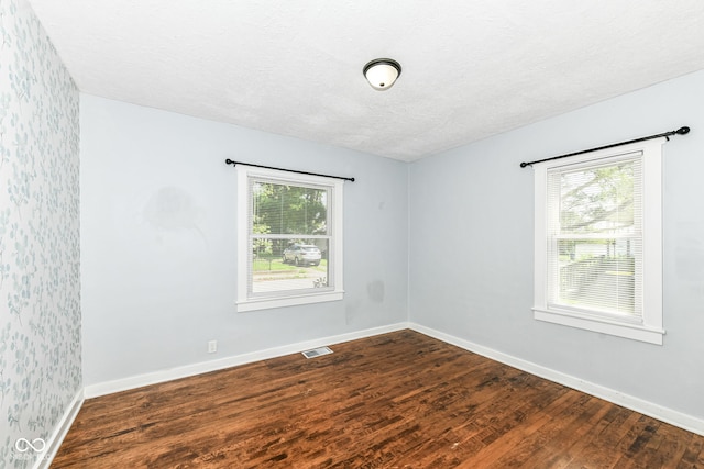 402 E 4th St, Sheridan, IN 46069 - unfurnished room with dark wood finished floors, baseboards, and a textured ceiling