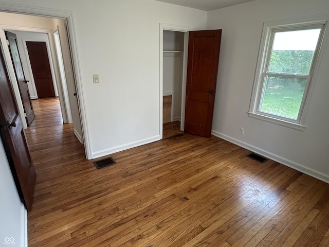 330 S Butler Ave, Indianapolis, IN 46219 - unfurnished bedroom featuring wood finished floors and a closet