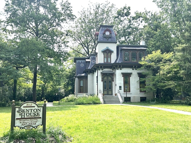 330 S Butler Ave, Indianapolis, IN 46219 - view of front of house with mansard roof, a front lawn, and view of wooded area