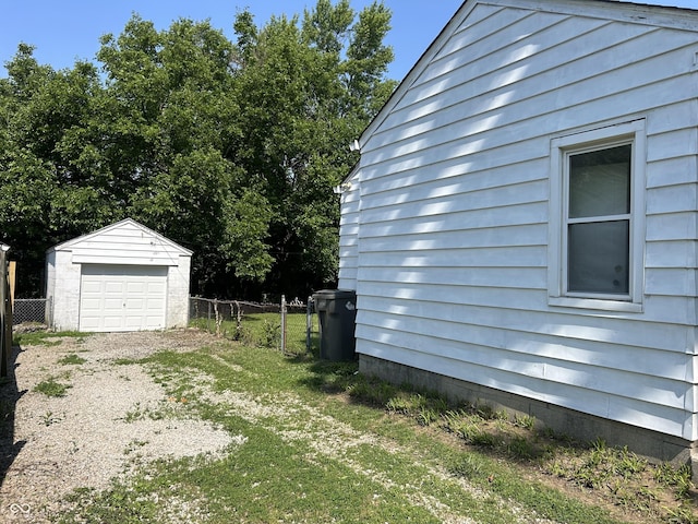 330 S Butler Ave, Indianapolis, IN 46219 - view of yard with a detached garage, dirt driveway, and an outdoor structure