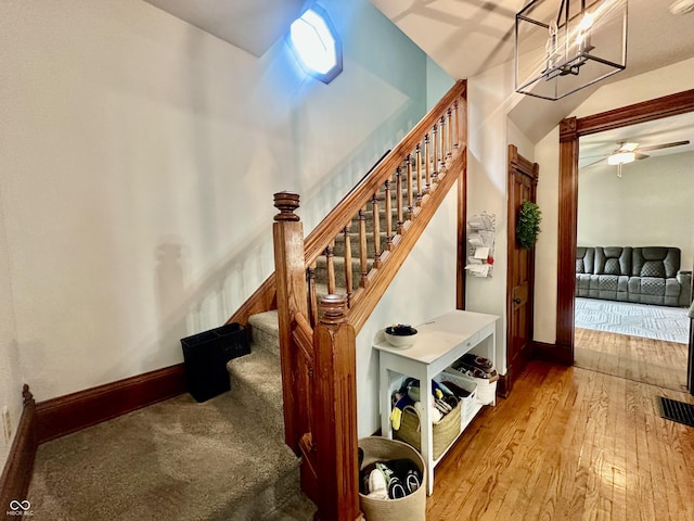 211 6th St, Covington, IN 47932 - stairs with baseboards, hardwood / wood-style flooring, and ceiling fan
