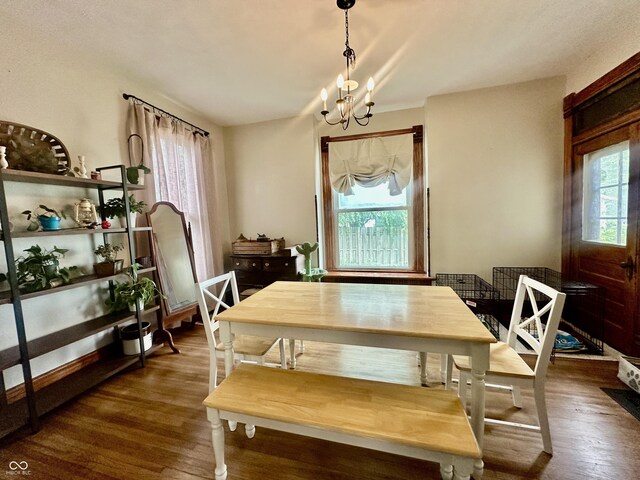211 6th St, Covington, IN 47932 - dining space featuring a chandelier and dark wood-style floors