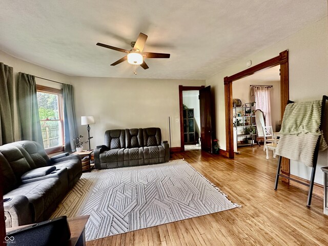 211 6th St, Covington, IN 47932 - living area featuring ceiling fan, wood finished floors, and baseboards