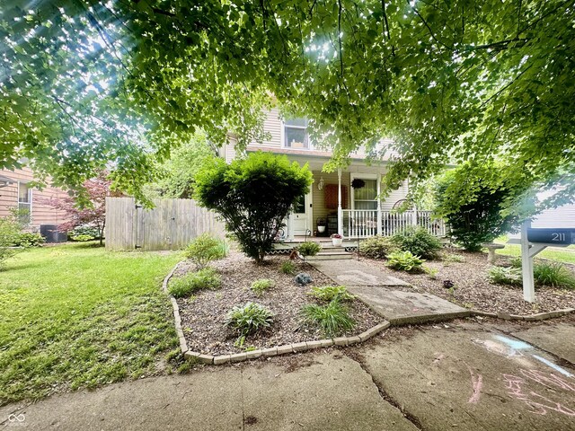 211 6th St, Covington, IN 47932 - view of property hidden behind natural elements featuring a porch