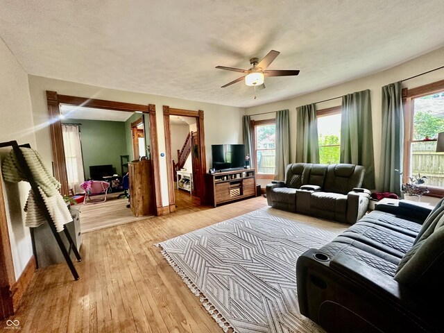 211 6th St, Covington, IN 47932 - living area with light wood finished floors, a ceiling fan, baseboards, and a textured ceiling