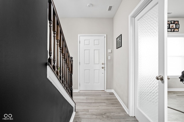 6305 N Woodhaven Dr, Mccordsville, IN 46055 - doorway to outside with light wood-style floors, baseboards, and stairs