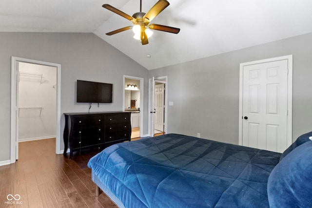 603 Daviess Dr, Westfield, IN 46074 - bedroom with wood finished floors, lofted ceiling, a walk in closet, ceiling fan, and baseboards