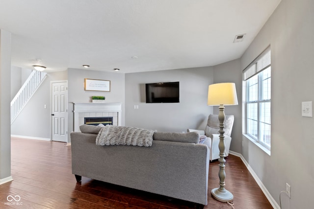 603 Daviess Dr, Westfield, IN 46074 - living area featuring dark wood finished floors, baseboards, and a tiled fireplace