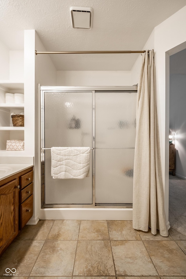 8223 Thoroughbred Run, Indianapolis, IN 46256 - bathroom with a shower stall, vanity, and a textured ceiling