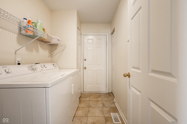 8223 Thoroughbred Run, Indianapolis, IN 46256 - laundry area featuring separate washer and dryer, baseboards, and light tile patterned floors