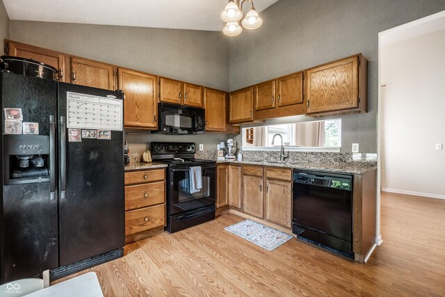 8223 Thoroughbred Run, Indianapolis, IN 46256 - kitchen with black appliances, light wood-type flooring, a sink, brown cabinets, and high vaulted ceiling