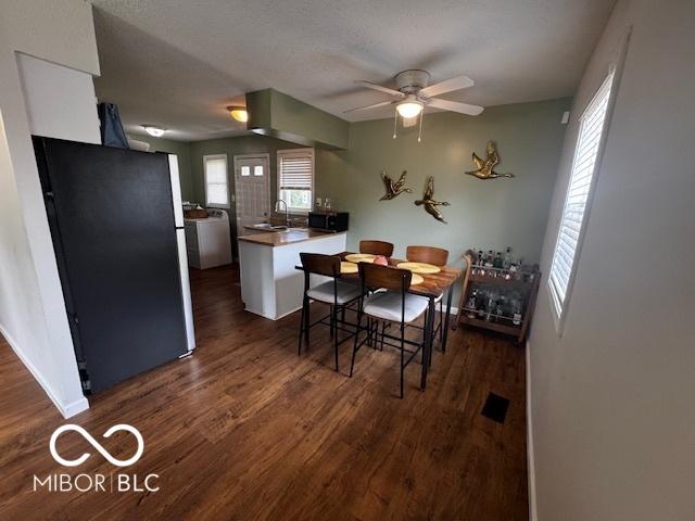 1820 Martin St, Indianapolis, IN 46237 - dining area with dark wood-type flooring, a ceiling fan, washer / clothes dryer, and baseboards