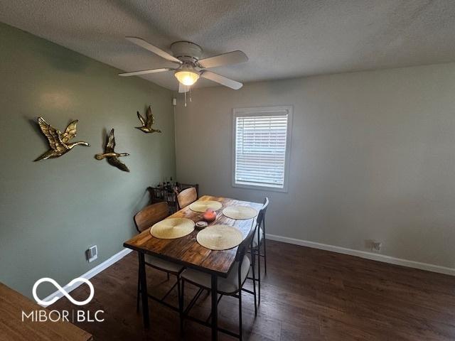 1820 Martin St, Indianapolis, IN 46237 - dining room featuring a ceiling fan, baseboards, a textured ceiling, and wood finished floors