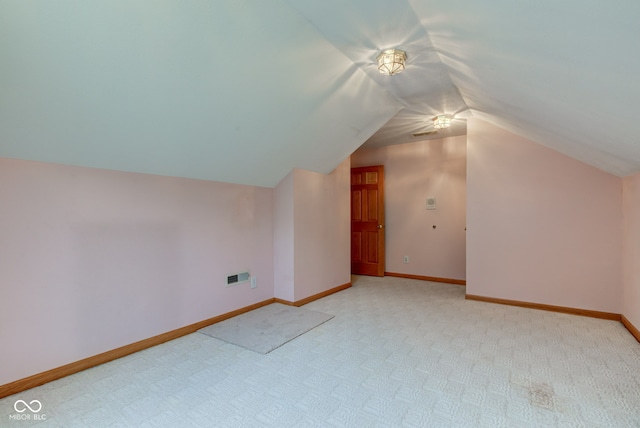 8371 N 400 W, Fairland, IN 46126 - additional living space with light carpet, vaulted ceiling, and baseboards