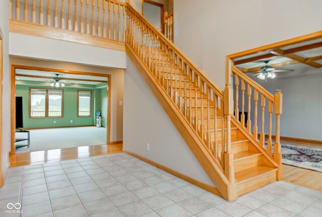 8371 N 400 W, Fairland, IN 46126 - stairway featuring a ceiling fan, baseboards, tile patterned floors, and a towering ceiling
