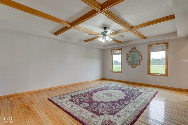 8371 N 400 W, Fairland, IN 46126 - unfurnished room featuring coffered ceiling, light wood-style flooring, baseboards, ceiling fan, and beam ceiling