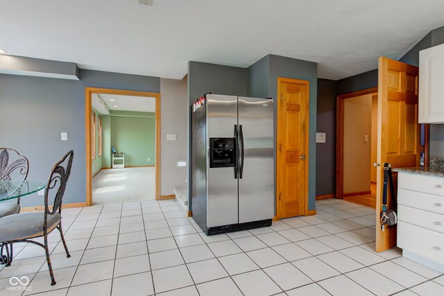 8371 N 400 W, Fairland, IN 46126 - kitchen with stainless steel fridge with ice dispenser, white cabinets, baseboards, and light stone counters