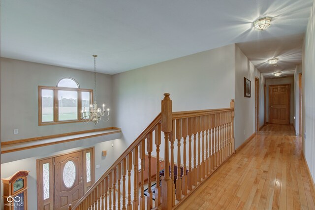 8371 N 400 W, Fairland, IN 46126 - hall with an upstairs landing, a chandelier, and wood-type flooring