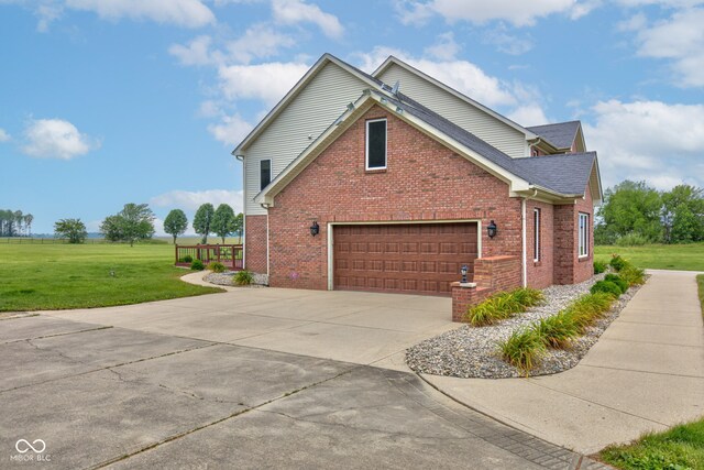 8371 N 400 W, Fairland, IN 46126 - view of property exterior with brick siding, a yard, driveway, and an attached garage