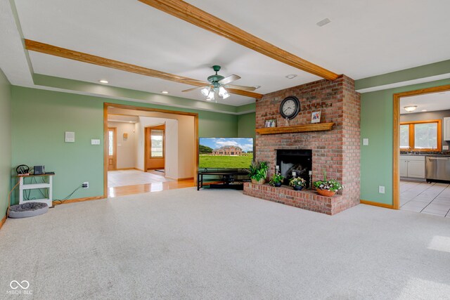 8371 N 400 W, Fairland, IN 46126 - living room featuring plenty of natural light, beamed ceiling, a ceiling fan, light carpet, and a brick fireplace