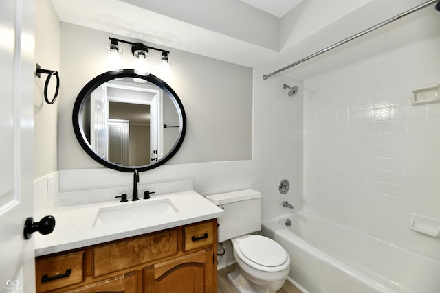 1053 Millwood Ct Unit 3, Indianapolis, IN 46260 - bathroom with vanity, toilet,  shower combination, tile walls, and wainscoting