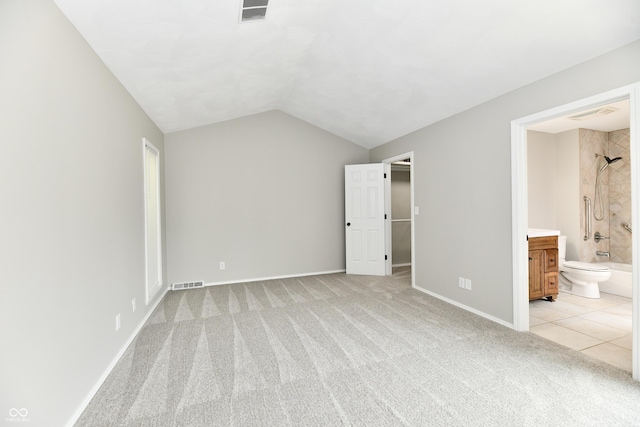 1053 Millwood Ct Unit 3, Indianapolis, IN 46260 - unfurnished bedroom featuring light colored carpet, lofted ceiling, baseboards, and connected bathroom