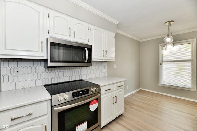 1053 Millwood Ct Unit 3, Indianapolis, IN 46260 - kitchen featuring appliances with stainless steel finishes, white cabinetry, light countertops, and crown molding