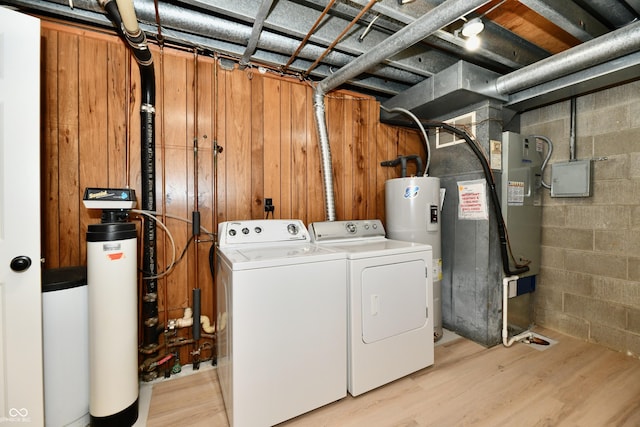 1053 Millwood Ct Unit 3, Indianapolis, IN 46260 - laundry room with washing machine and dryer, water heater, concrete block wall, heating unit, and light wood finished floors