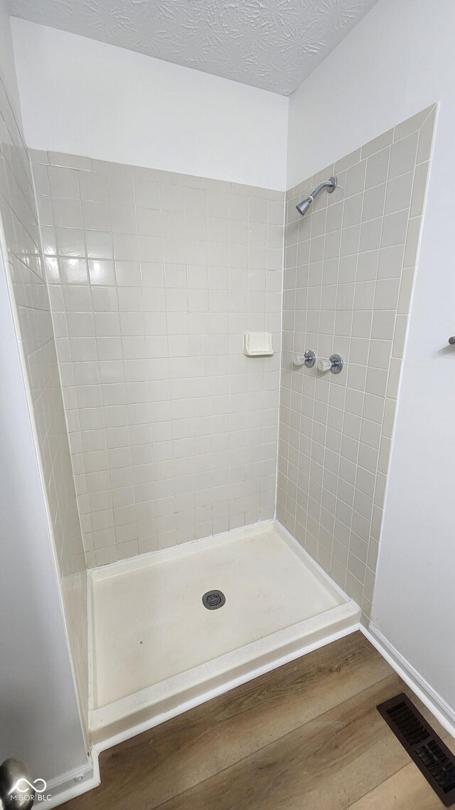 1836 Queensbridge Cir, Indianapolis, IN 46219 - bathroom featuring wood finished floors, a stall shower, and baseboards