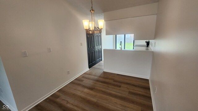 1836 Queensbridge Cir, Indianapolis, IN 46219 - unfurnished dining area featuring dark wood finished floors, a chandelier, a sink, and baseboards