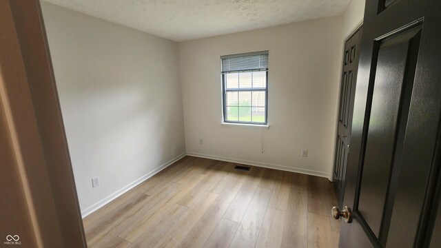 1836 Queensbridge Cir, Indianapolis, IN 46219 - unfurnished bedroom featuring wood finished floors and baseboards