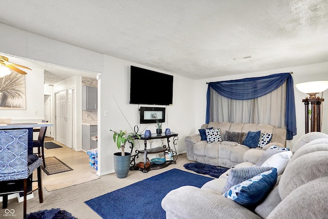 2832 Hillside Ave, Indianapolis, IN 46218 - living area featuring light carpet, a textured ceiling, and ceiling fan