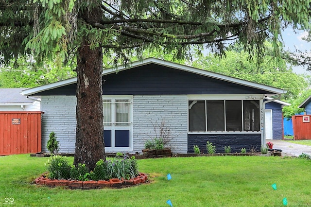 2832 Hillside Ave, Indianapolis, IN 46218 - view of front of house featuring brick siding and a sunroom