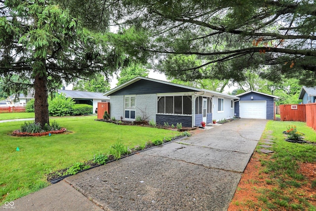 2832 Hillside Ave, Indianapolis, IN 46218 - ranch-style house with an outbuilding, driveway, a sunroom, and brick siding
