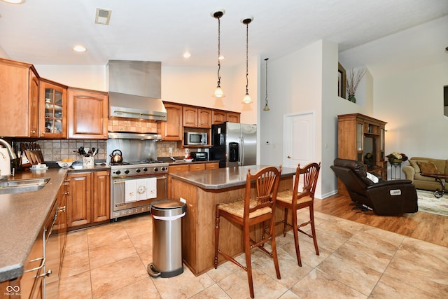 2805 Rylee Ct, Greenwood, IN 46143 - kitchen featuring appliances with stainless steel finishes, a sink, wall chimney exhaust hood, glass insert cabinets, and brown cabinets
