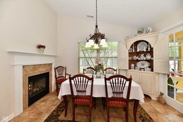 2805 Rylee Ct, Greenwood, IN 46143 - dining area featuring a chandelier, vaulted ceiling, and a fireplace