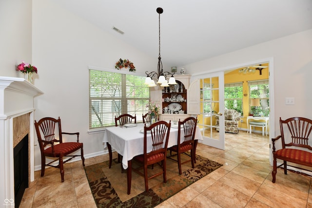 2805 Rylee Ct, Greenwood, IN 46143 - dining space featuring a fireplace, healthy amount of natural light, a chandelier, and lofted ceiling