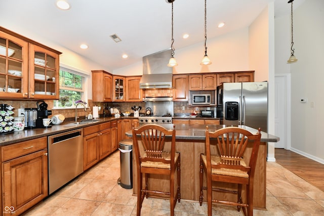 2805 Rylee Ct, Greenwood, IN 46143 - kitchen with appliances with stainless steel finishes, vaulted ceiling, a sink, wall chimney range hood, and brown cabinets