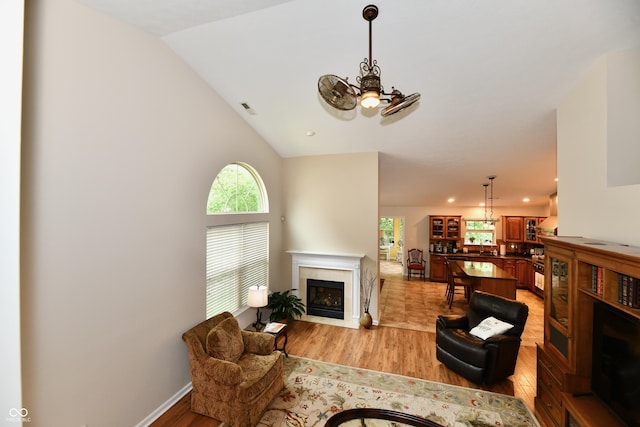 2805 Rylee Ct, Greenwood, IN 46143 - living room with light wood-style flooring, a fireplace with flush hearth, and lofted ceiling