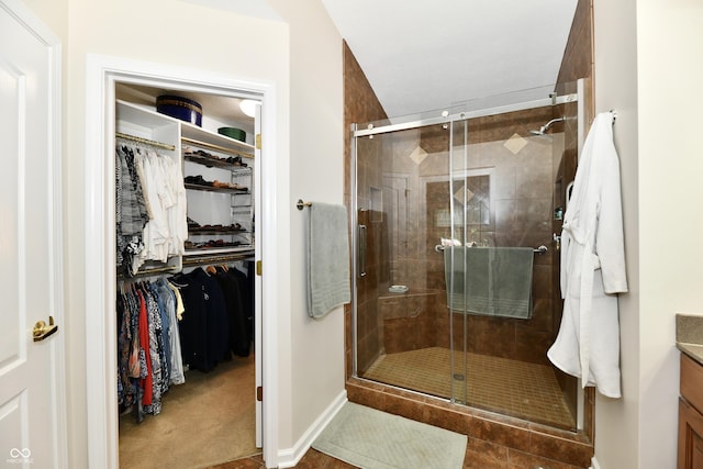 2805 Rylee Ct, Greenwood, IN 46143 - full bathroom with vanity, a shower stall, a walk in closet, and baseboards
