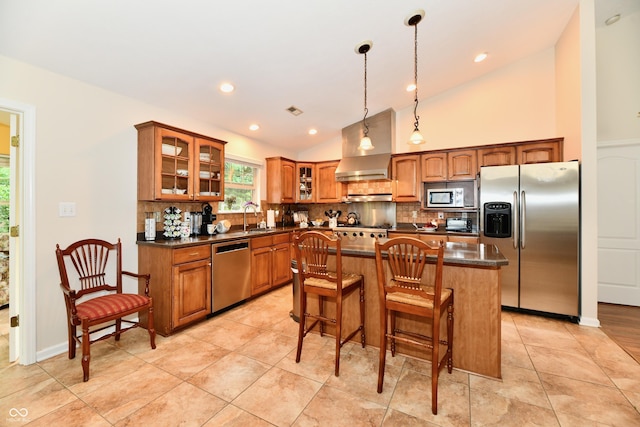 2805 Rylee Ct, Greenwood, IN 46143 - kitchen featuring appliances with stainless steel finishes, lofted ceiling, wall chimney range hood, backsplash, and brown cabinets