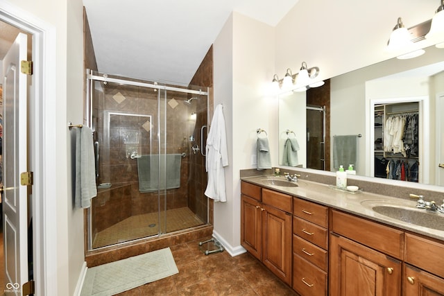 2805 Rylee Ct, Greenwood, IN 46143 - full bathroom featuring a spacious closet, double vanity, tile patterned flooring, a shower stall, and baseboards
